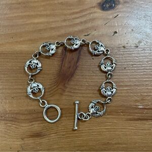 Vintage: Art Deco 8 Irish Claddaghs round 7’ inch silver toggle link bracelet.